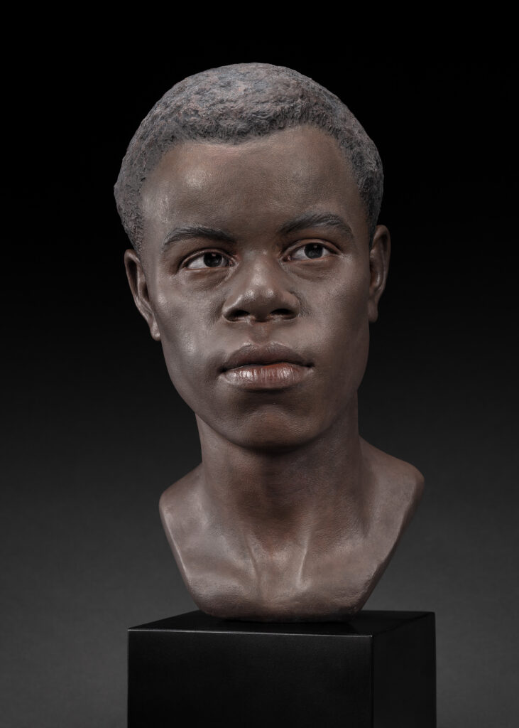 A photo of a facial reconstruction of one of the individuals , a teenage male, found at Cactoctin Furnace.